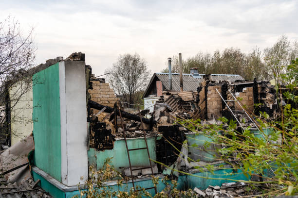 Demolished residential structure with burnt walls and debris, illustrating ADX Excavating's demolition services in Souderton, PA.